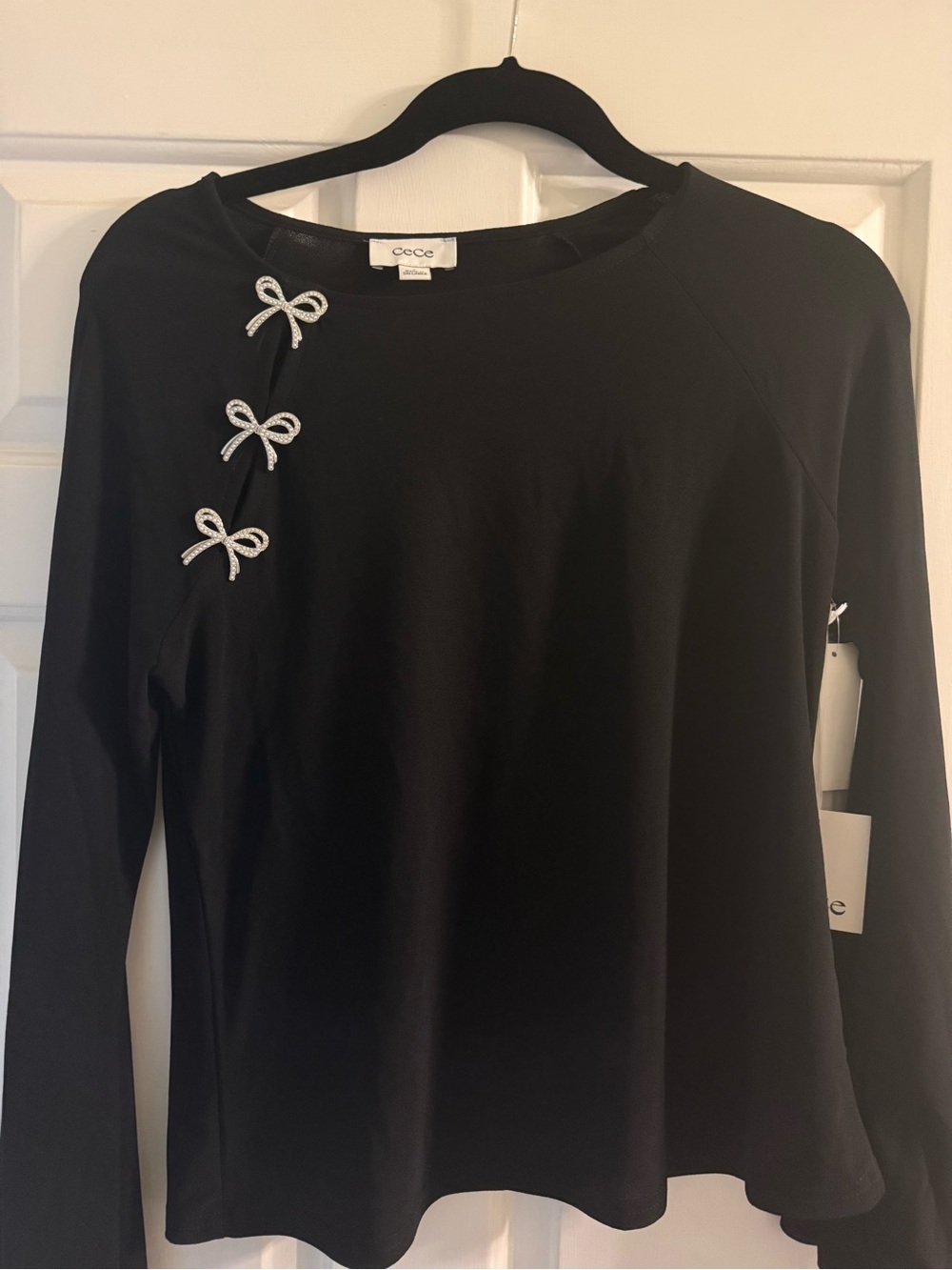 CeCe Black Long Sleeve Top with Rhinestone Bow Accents